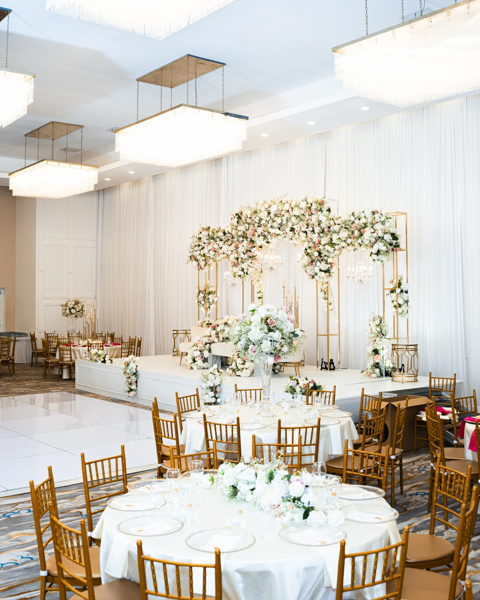 Full hall view with gold chiavari chairs