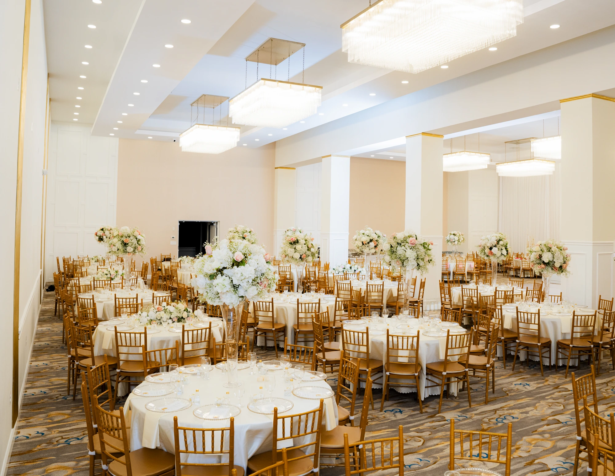 Ballroom with gold columns and chandeliers