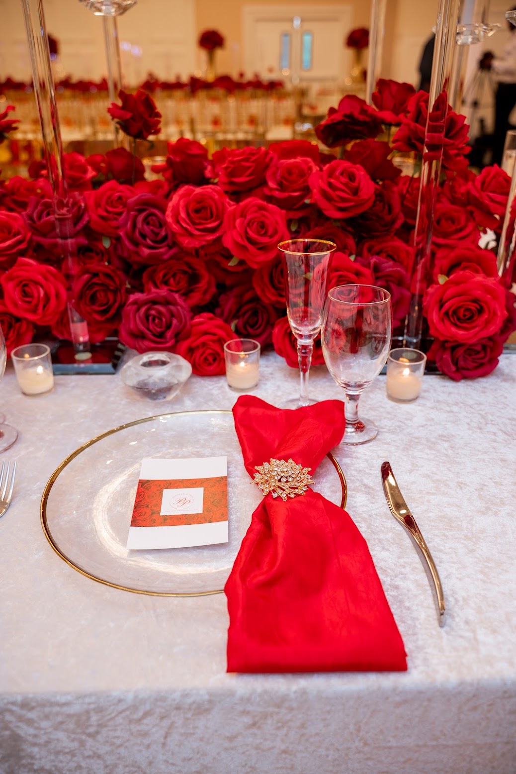 Red rose centerpieces along the head table